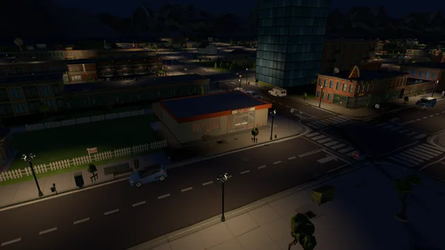 The florist at night under the street lamps, the church and town lights behind it